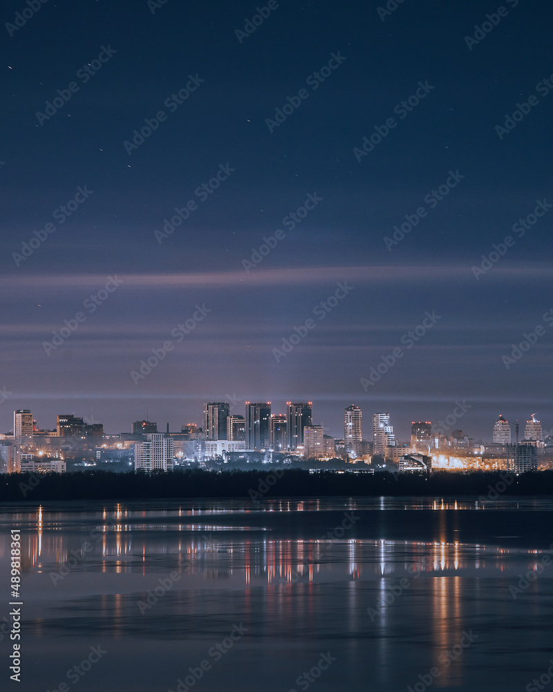 the city of Dnipro. Panoramic view of the night city from the river. Ukraine.