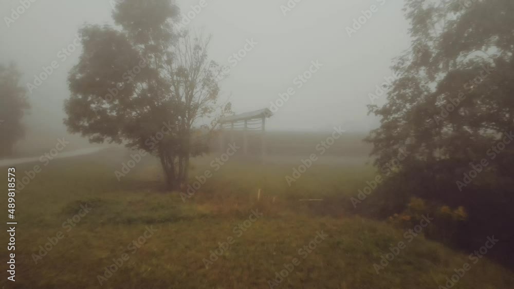 Freestanding Single Straight-line Hayrack On A Foggy Morning Near Rural Crops In Countryside Fields. - aerial Freestanding Single Straight-line Hayrack On A Foggy Morning Near Rural Crops In Countryside Fields. - aerial