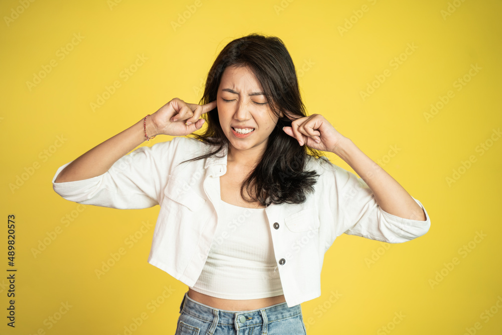 asian female does not want to hear too loud noise asian female does not want to hear too loud noise