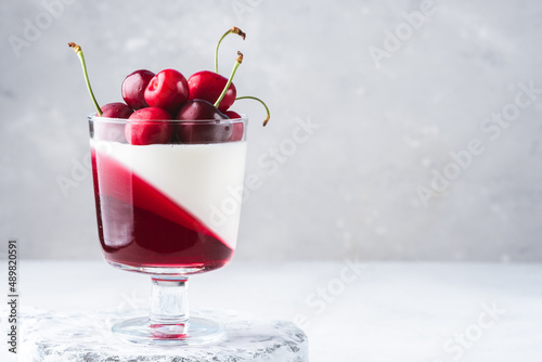 Delisious panna cotta summer dessert with cherries and cherry jelly photo