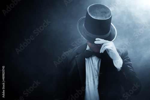 Fotografie, Obraz Mysterious man in black suit on dark background