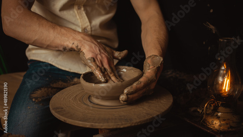 Slika na platnu man makes Plate in pottery workshop, clay product, authentic atmosphere, background, footage