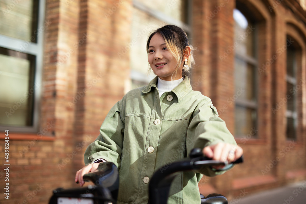 Beautiful woman getting ready for a ride. Beautiful happy lady with electric bicycle... Beautiful woman getting ready for a ride. Beautiful happy lady with electric bicycle...