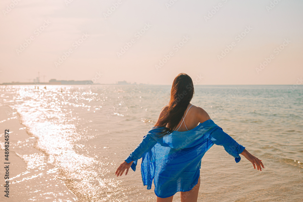 Woman on the beach enjoying summer holidays