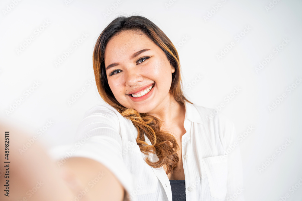 Asian woman holding a smart phone for selfie or video call Asian woman holding a smart phone for selfie or video call