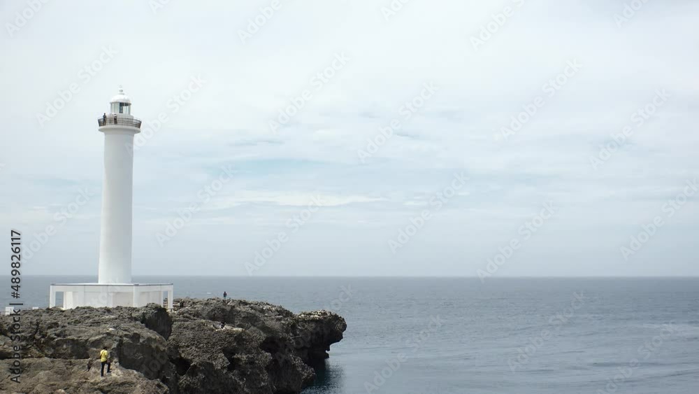 YOMITANSON, OKINAWA, JAPAN - AUG 2021 : View of lighthouse at Zanpa Misaki (Cape Zanpa) and East China Sea (Ocean). Wide view, time lapse shot in day. Summer holiday, vacation and resort concept video YOMITANSON, OKINAWA, JAPAN - AUG 2021 : View of lighthouse at Zanpa Misaki (Cape Zanpa) and East China Sea (Ocean). Wide view, time lapse shot in day. Summer holiday, vacation and resort concept video
