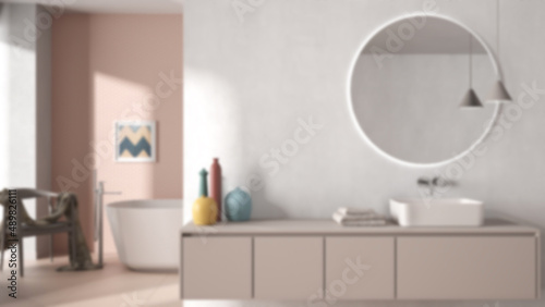 Blur background  cozy minimalist bathroom  washbasin with mirror  bathtub  tiles and concrete walls  armchair  colored vases and decors  interior design project concept idea