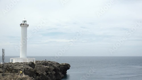 YOMITANSON, OKINAWA, JAPAN - AUG 2021 : View of lighthouse at Zanpa Misaki (Cape Zanpa) and East China Sea (Ocean). Wide view, time lapse shot in day. Summer holiday, vacation and resort concept video photo