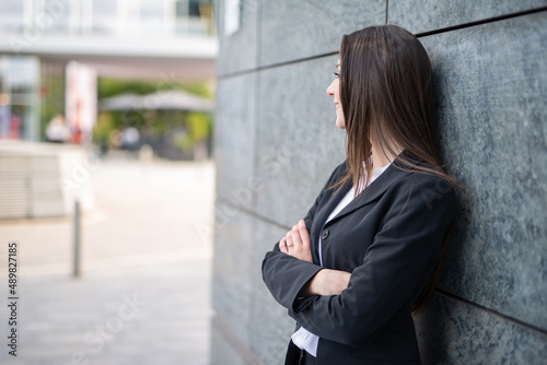 Businesswoman leaning against a wall photo