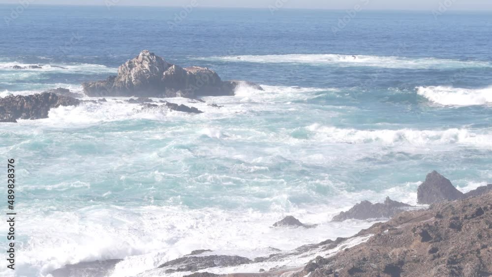Rocky craggy ocean beach. Big waves crashing on bare cliff, blue water splashing, sea foam. Power of nature near Big Sur, 17-mile drive. Dramatic seascape. Point Lobos, Monterey, California coast, USA Rocky craggy ocean beach. Big waves crashing on bare cliff, blue water splashing, sea foam. Power of nature near Big Sur, 17-mile drive. Dramatic seascape. Point Lobos, Monterey, California coast, USA
