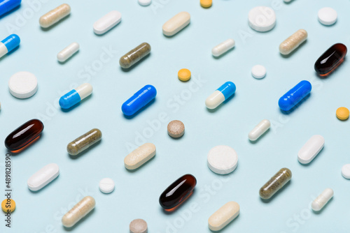 Medical pills drugs pattern assortment on blue background