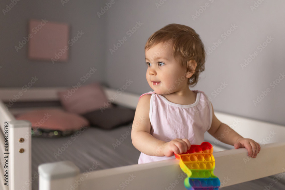 A little girl is playing with a pop it toy. An exciting sensory toy for development A little girl is playing with a pop it toy. An exciting sensory toy for development