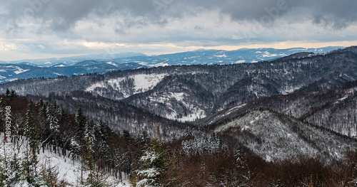 Nearer hills of Kysucke Beskydy and Moravskoslezske Beskydy mountains on the background during mostly cloudy winter day