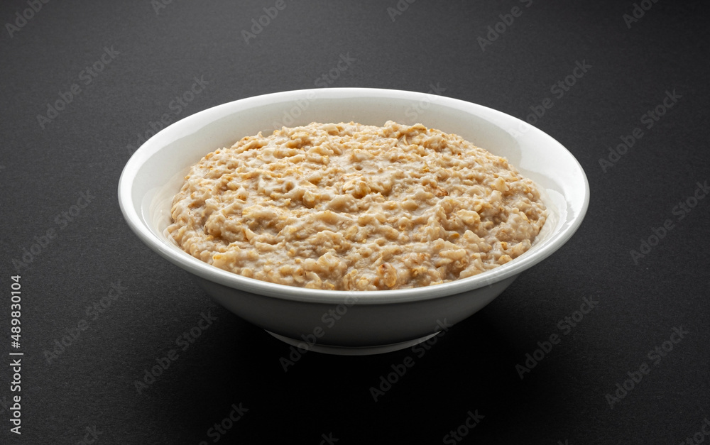 Bowl of oatmeal on black background Bowl of oatmeal on black background