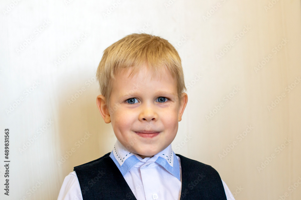 Smiling ittle blond boy in school uniform Smiling ittle blond boy in school uniform