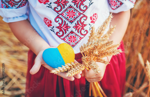 Child in a wheat field. In vyshyvanka, the concept of the Independence Day of Ukraine. Selective focus. photo