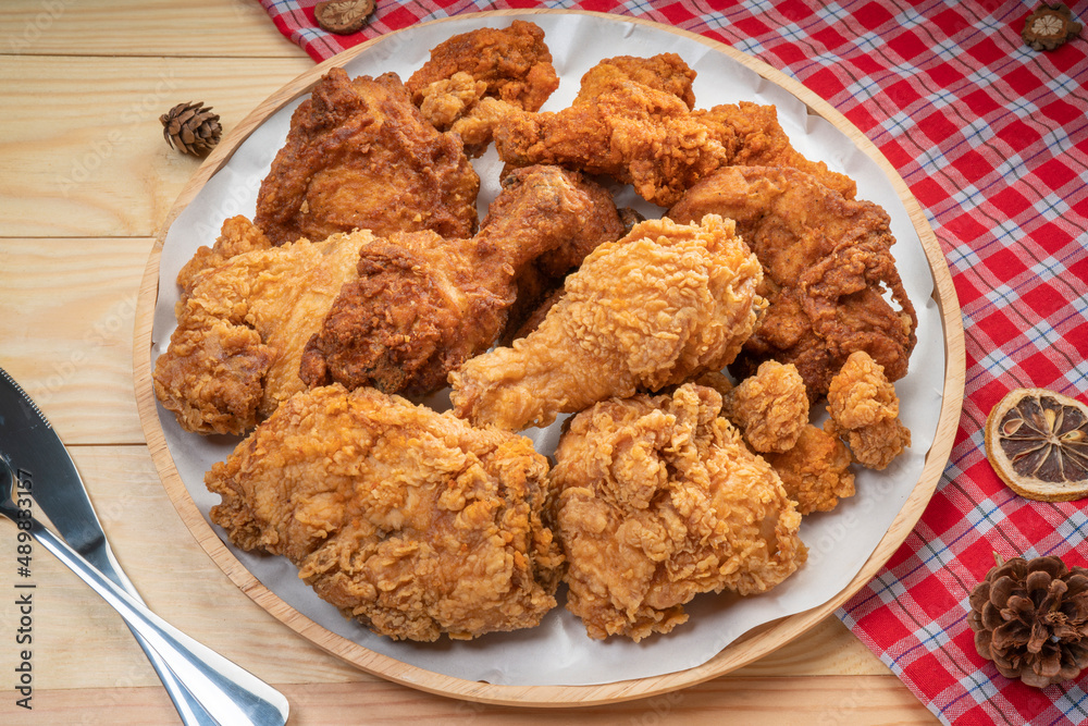 Fried chicken in wooden plate on wooden background, Deep fry Chicken on wooden table. Fried chicken in wooden plate on wooden background, Deep fry Chicken on wooden table.