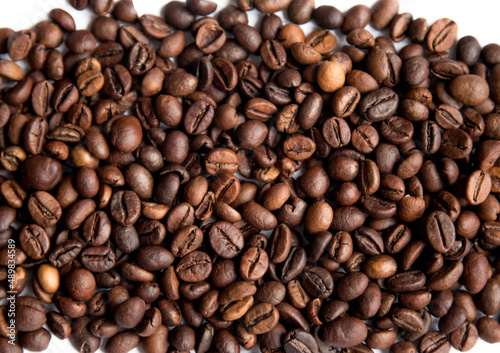 Roasted coffee beans on a white background. Coffee texture.