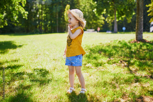 Happy cheerful toddler girl walking in park © Ekaterina Pokrovsky