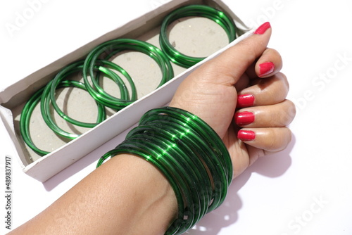 Woman's many bangles on her wrist Isolated white background photo