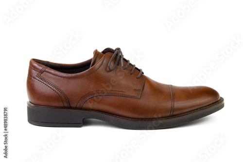 Single unbranded brown leather men’s shoe isolated on white background, side view. Fashion and shopping concept