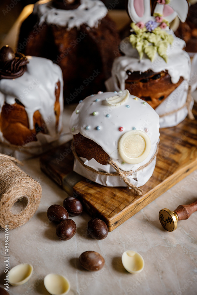 Easter, Easter cake on a dark background with a complex composition, beautiful scenery, dried fruits, movement, hands Easter, Easter cake on a dark background with a complex composition, beautiful scenery, dried fruits, movement, hands