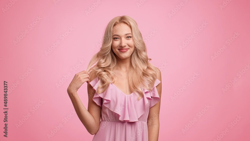 Gorgeous Lady Playing With Curled Blonde Hair Over Pink Background Gorgeous Lady Playing With Curled Blonde Hair Over Pink Background