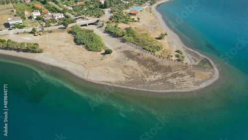 Aerial drone photo of picturesque seaside village and beach of Eratini in Fokida prefecture as seen in summer, Greece photo