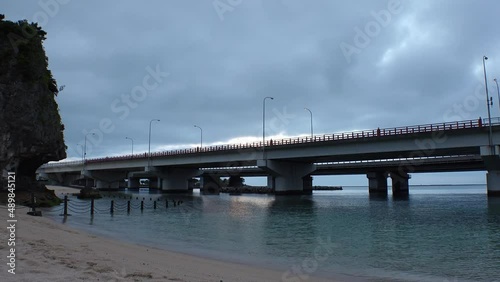 Wallpaper Mural NAHA, OKINAWA, JAPAN - AUG 2021 : View of Naminoue beach (Ocean or sea) and road traffic in sunset time. Wide view, time lapse shot, dusk to night. Summer holiday, vacation and resort concept shot. Torontodigital.ca