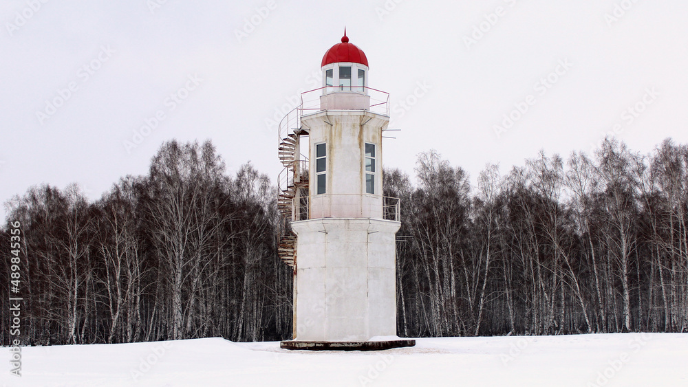 Old white lighthouse in winter