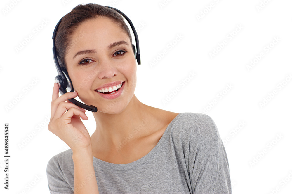 Friendly support with a smile. Studio shot of a young woman wearing a hands-free headset. Friendly support with a smile. Studio shot of a young woman wearing a hands-free headset.