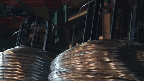 The factory produces copper wire. It is wound on special mechanisms in large rolls. it glows red