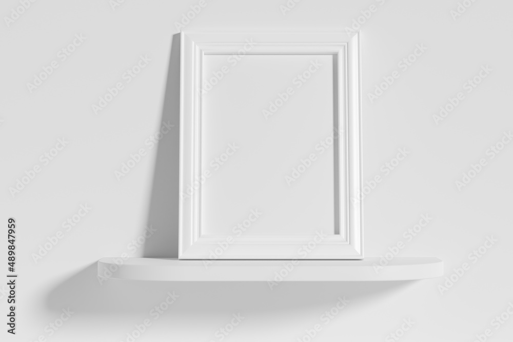 Rectangular photo frame on white rounded shelf leaning at wall Rectangular photo frame on white rounded shelf leaning at wall