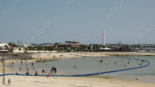 CHATAN-CHO, OKINAWA, JAPAN - AUGUST 2021 : View of Chatan sunset beach (Ocean or sea). Wide view, time lapse shot in daytime. Summer holiday, vacation and resort concept video. photo