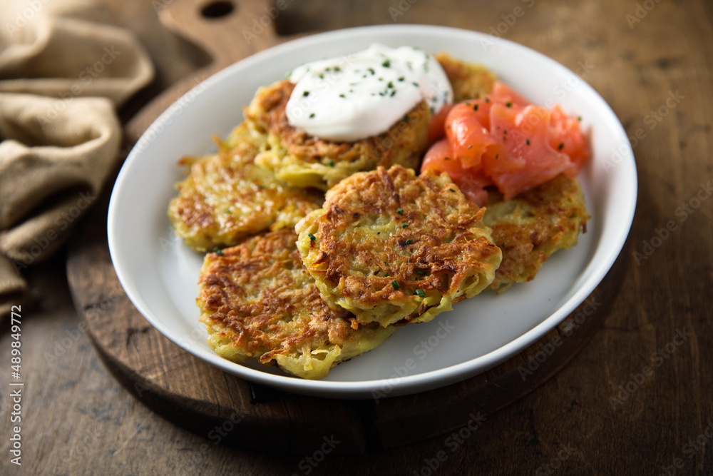 Homemade potato pancakes or lakes with salmon