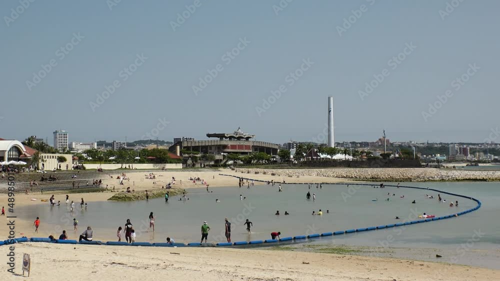 CHATAN-CHO, OKINAWA, JAPAN - AUGUST 2021 : View of Chatan sunset beach (Ocean or sea). Wide view, time lapse shot in daytime. Summer holiday, vacation and resort concept video. CHATAN-CHO, OKINAWA, JAPAN - AUGUST 2021 : View of Chatan sunset beach (Ocean or sea). Wide view, time lapse shot in daytime. Summer holiday, vacation and resort concept video.