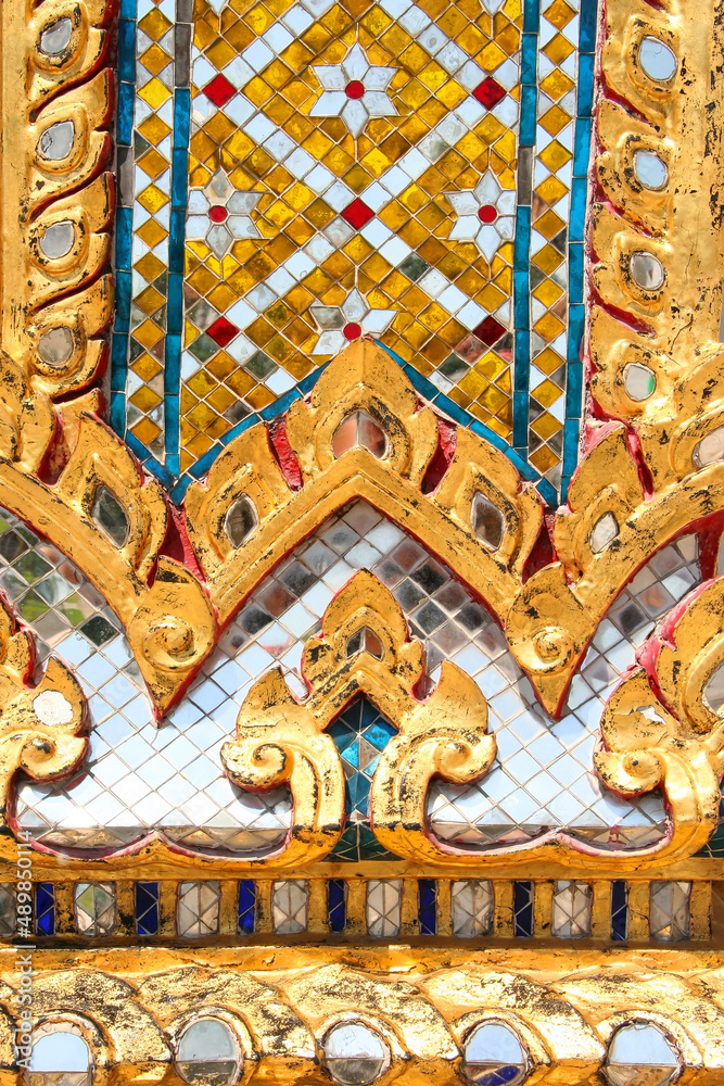 Golden Pattern at Wat Pho in Bangkok, Thailand with Floral Design of shapes and color. Vintage thai golden pattern with gems. Asian golden ornament in Thailand. Traditional decorative background