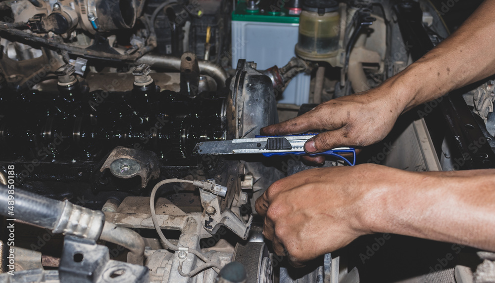 The mechanic is checking the engine. The mechanic is checking the engine.