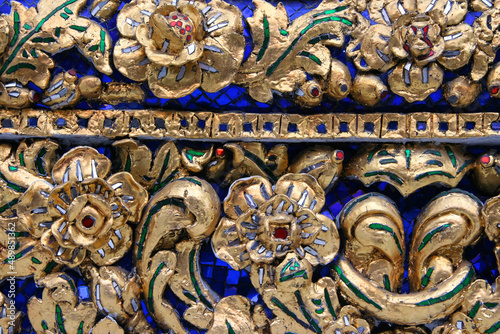 Golden Pattern at Wat Pho in Bangkok  Thailand with Floral Design of shapes and color. Vintage thai golden pattern with gems. Asian golden ornament in Thailand. Traditional decorative background