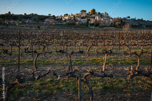 the provencal village of Joucas in the luberon national park  with vineyard in the forground in late winter , provence ,vaucluse ,France . photo