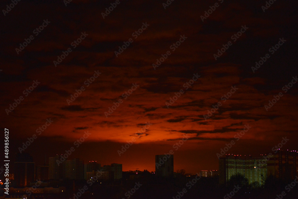 Kyiv/Ukraine - 26 February, 2022: The burning sky in Kyiv due to a fire at the Vasylkiv oil depot. Russian troops who invaded Ukraine fired rockets at an oil depot near Kyiv.