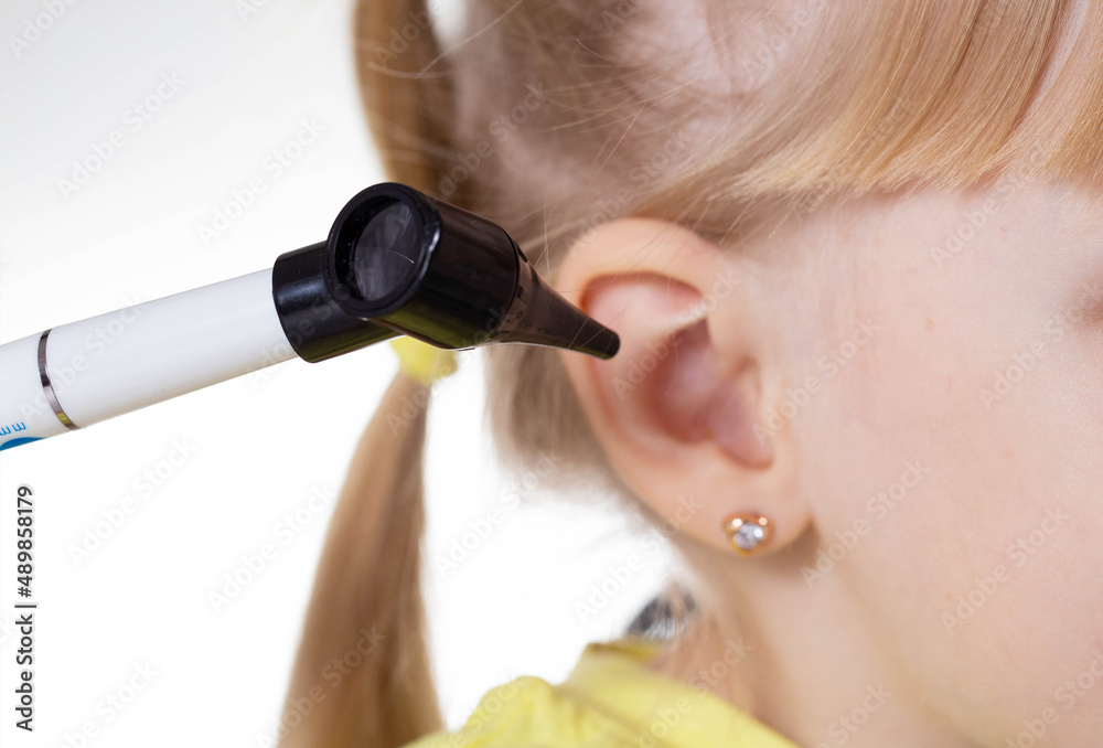 Doctor ENT doctor conducts an otoscopy with a device, closeup