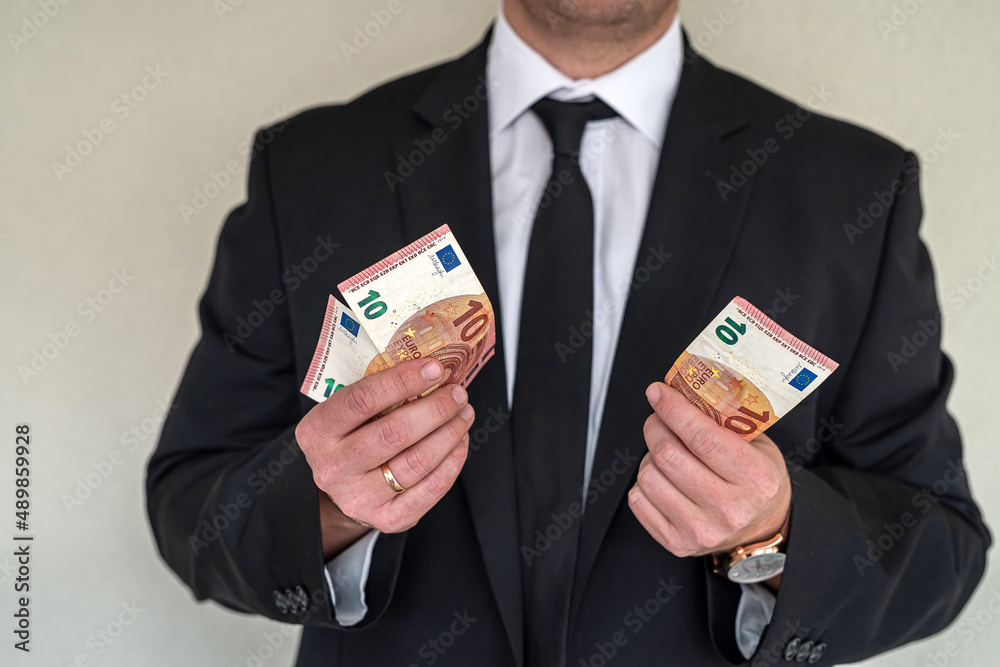 Businessman in classic black suit got euro money Businessman in classic black suit got euro money