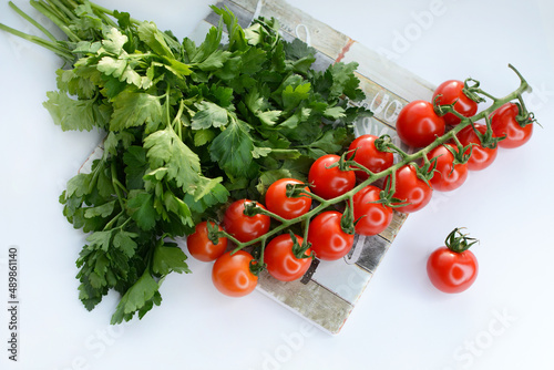 Ripe juicy cherry tomatoes on a wooden board