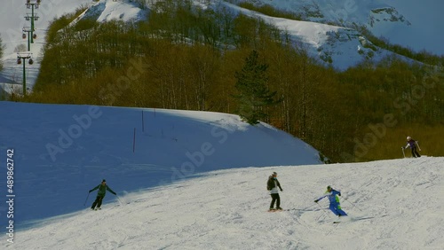 Skiers have fun on the ski slopes of the Aremogna ski area. Aremogna skyresort, Roccaraso, province of L'Aquila, Abruzzo, Italy photo