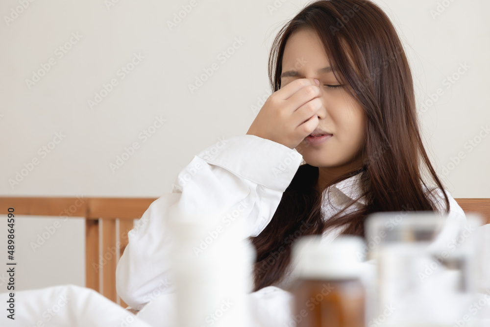 Asian woman feeling sick have a headache, coughing because of Coronavirus Covid-19. Protection and recovery from the illness quarantine at home, Stay at home. Asian woman feeling sick have a headache, coughing because of Coronavirus Covid-19. Protection and recovery from the illness quarantine at home, Stay at home.