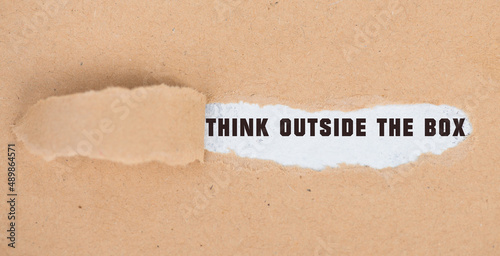 Think outside the box is standing on pieces paper, brainstorming for new ideas, being innovative, business concept 