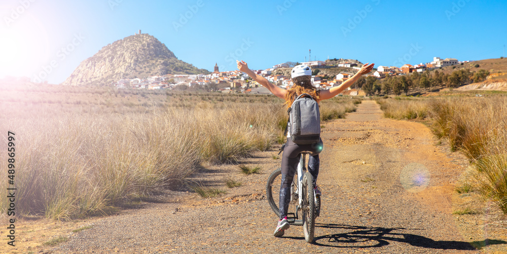 happy woman by bike in countryside,  Spain
