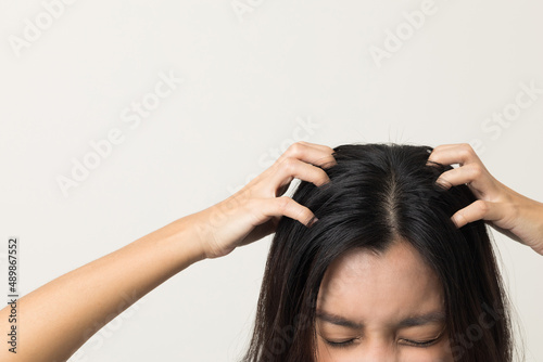 Young woman itchy head There is a fungus on the scalp dandruff, red rash She scratched her head to bring relief. Need to consult a doctor. Hair problems hair loss. Shot on isolated background