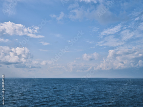 blue sea and fluffy clouds